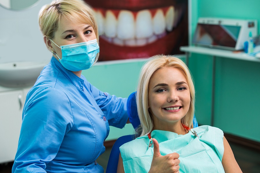 bigstock-Doctor-Dentist-And-Happy-Femal-232553398.jpg thumbnail image of blog post cavity prevention chances can be improved by a fluoride treatment