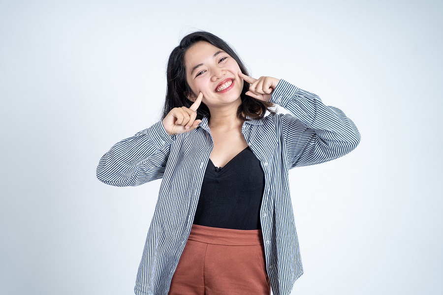 bigstock-Smiling-Young-Woman-Standing-W-452783335.jpg thumbnail image of blog post celebrate healthy teeth and gums with healthy foods and drinks